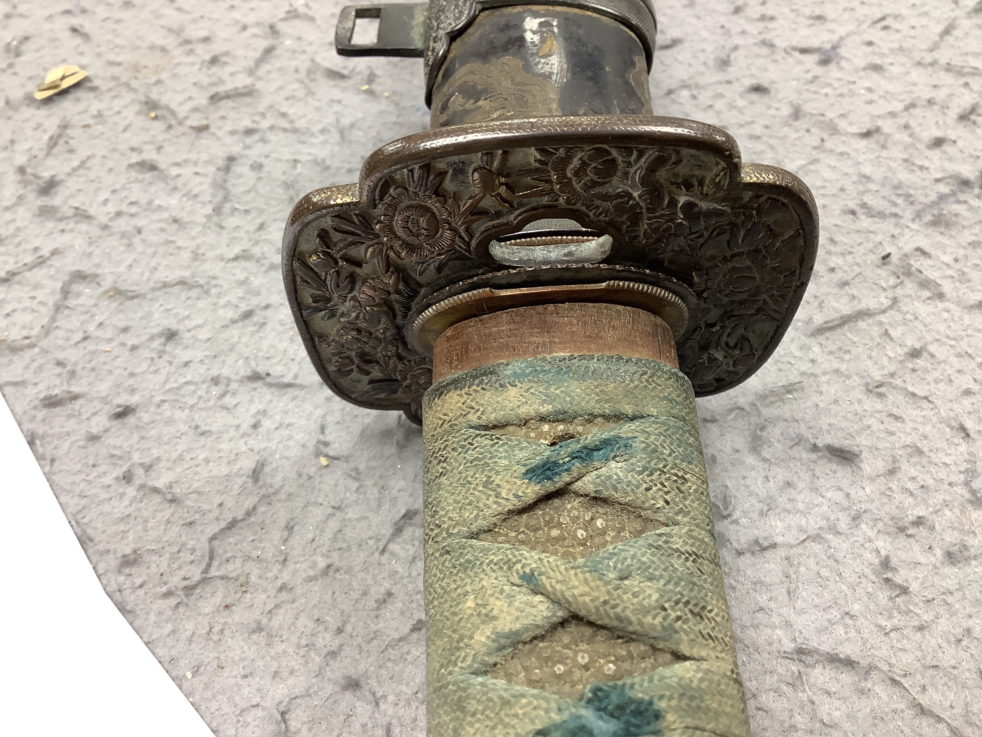 A 19th century Japanese katana with signature to the tang, with chiselled bronze tsuba and gilt metal menuki, and six various knives, blade 57cm